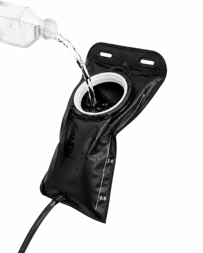1.5L CoreFlow hydration bladder in black being filled through the wide cap